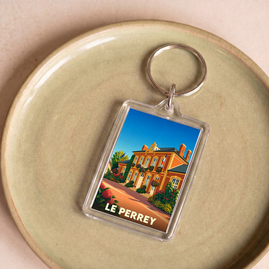 Porte-clés souvenir de la ville de Le Perrey avec une illustration stylisée.