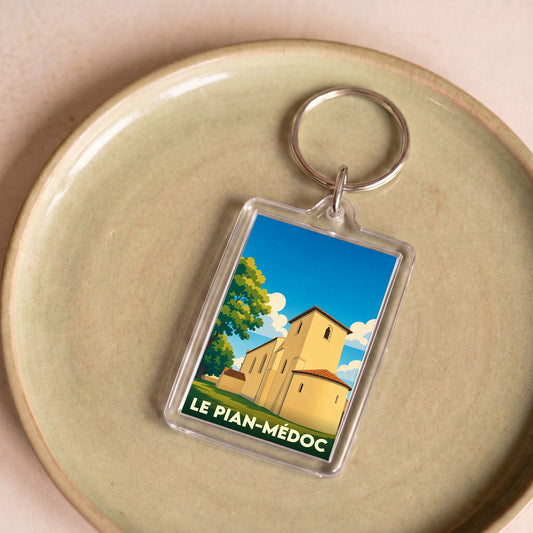 Porte-clés souvenir de la ville de Le Pian-Médoc avec une illustration stylisée de son église.