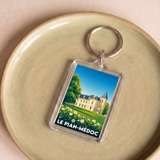 Porte-clés souvenir de la ville de Le Pian-Médoc avec une illustration stylisée d'un château.