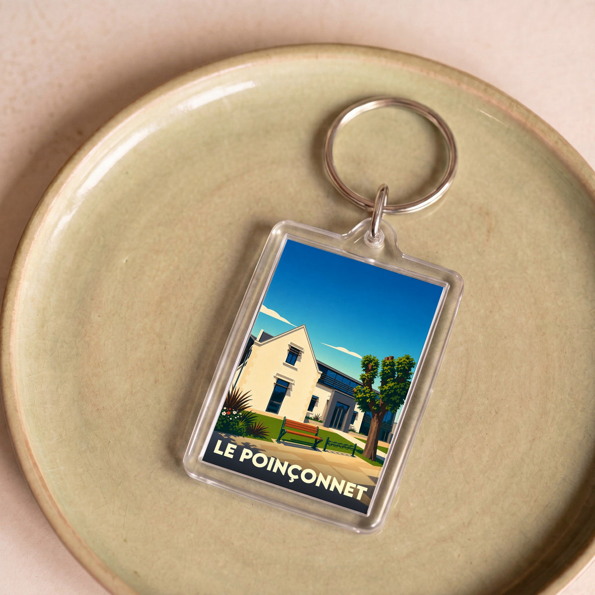 Porte-clés souvenir de la ville de Le Poinçonnet avec une illustration stylisée.