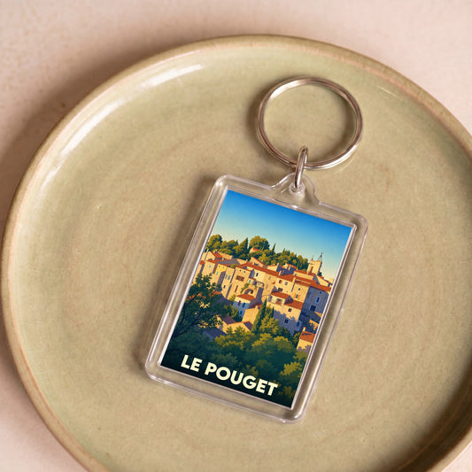 Porte-clés souvenir de la ville de Le Pouget avec une illustration stylisée.
