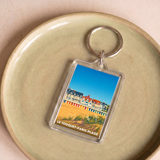 Porte-clés souvenir de la ville de Le Touquet-Paris-Plage avec une illustration stylisée de son front de mer.