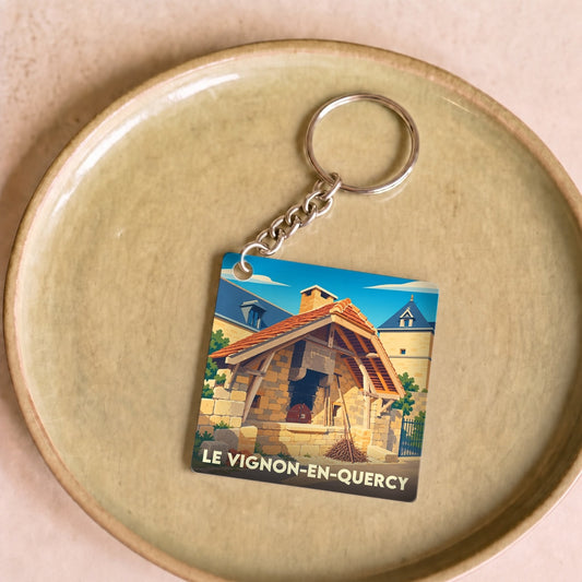 Porte-clés souvenir de la ville de Le Vignon-en-Quercy avec une illustration stylisée d'un four à pain traditionnel.