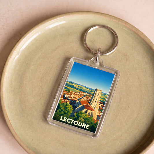 Porte-clés souvenir de la ville de Lectoure avec une illustration stylisée de ses toits et de sa cathédrale.