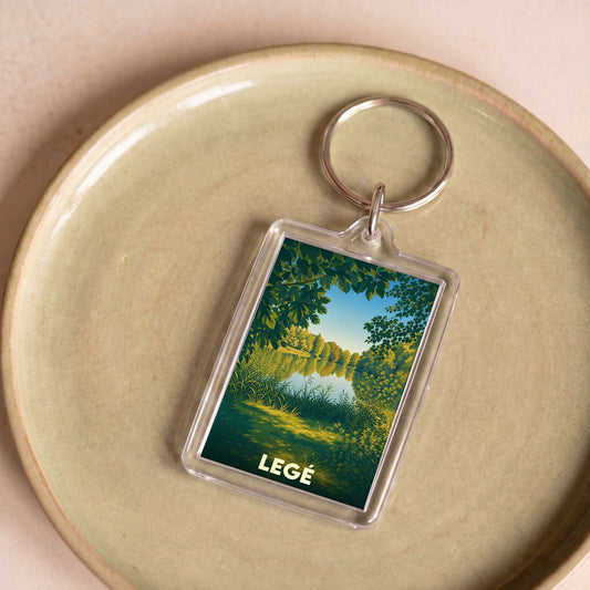 Porte-clés souvenir de la ville de Legé avec une illustration stylisée de paysage naturel.