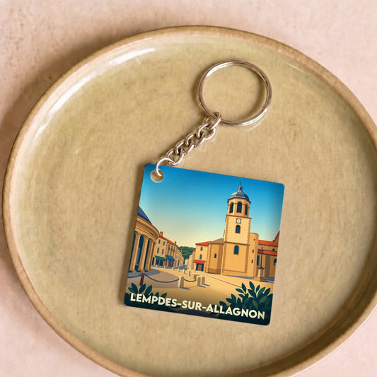 Porte-clés souvenir de la ville de Lempdes-sur-Allagnon avec une illustration stylisée.