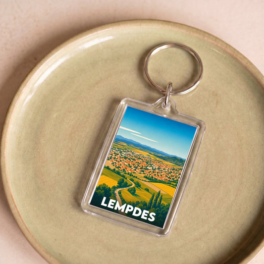 Porte-clés souvenir de la ville de Lempdes avec une illustration stylisée.