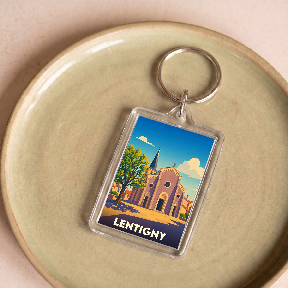 Porte-clés souvenir de la ville de Lentigny avec une illustration stylisée de son église.