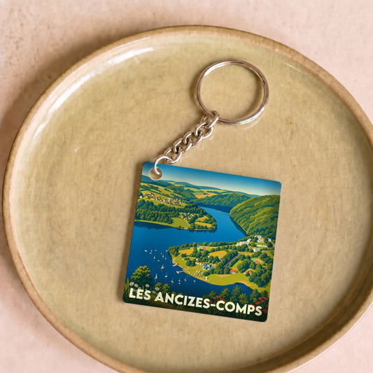 Porte-clés souvenir de la ville de Les Ancizes-Comps avec une illustration stylisée de son paysage.