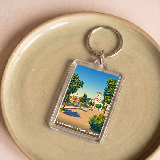 Porte-clés souvenir de la ville de Les Avenières Veyrins-Thuellin avec une illustration stylisée.
