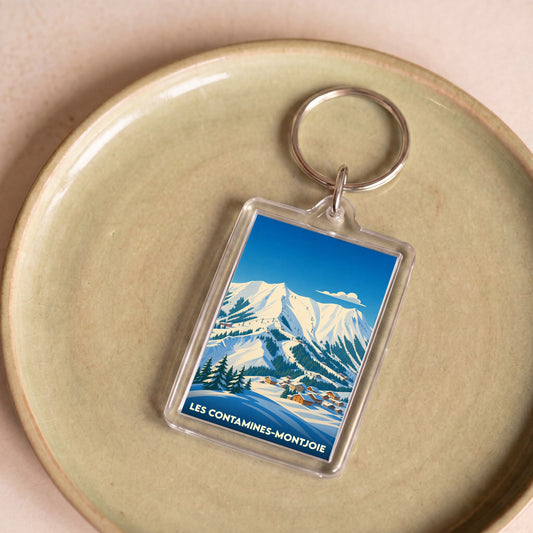 Porte-clés souvenir de la ville de Les Contamines-Montjoie avec une illustration hivernale stylisée.