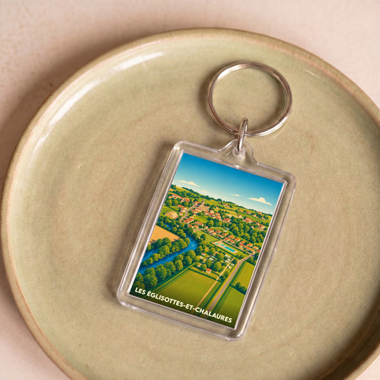 Porte-clés souvenir de la ville des Églisottes-et-Chalaures avec une illustration paysagère stylisée.