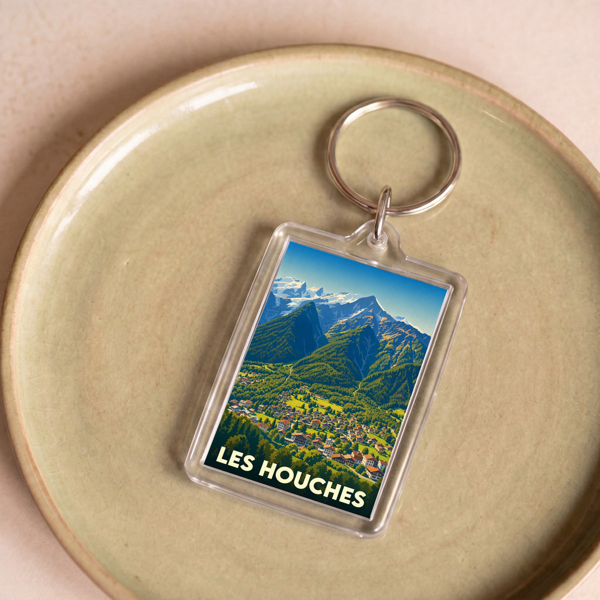 Porte-clés souvenir de la ville de Les Houches avec une illustration stylisée de montagne.