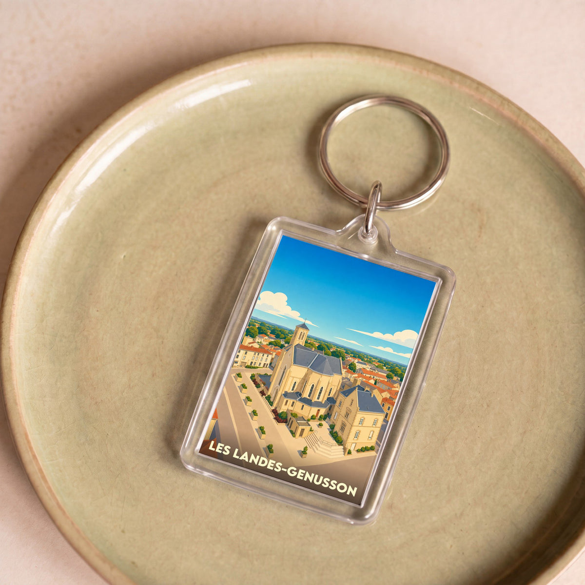 Porte-clés souvenir de la ville de Les Landes-Genusson avec une illustration stylisée.