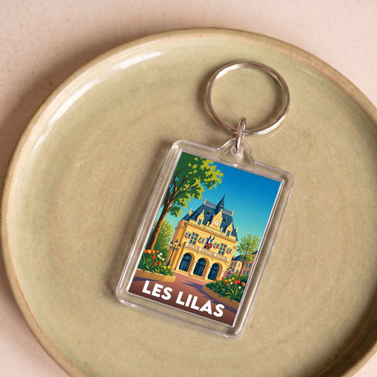 Porte-clés souvenir de la ville de Les Lilas avec une illustration stylisée de son hôtel de ville.