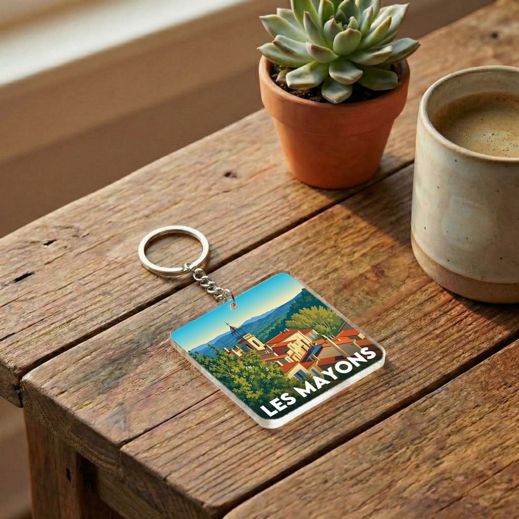 Porte-clés souvenir de la ville de Les Mayons avec une illustration stylisée.