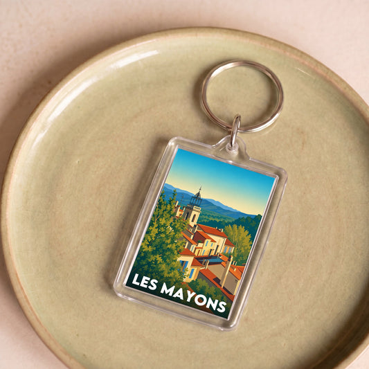 Porte-clés souvenir de la ville de Les Mayons avec une illustration stylisée.