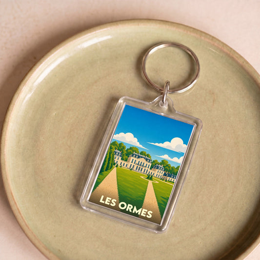 Porte-clés souvenir de la ville de Les Ormes avec une illustration stylisée d'un château.