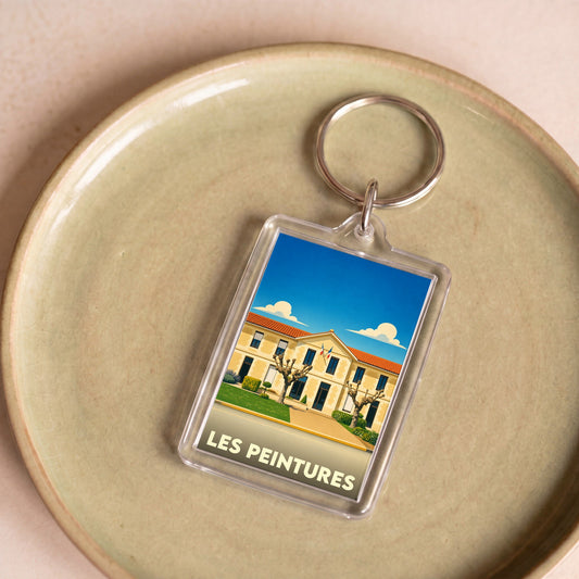 Porte-clés souvenir de la ville de Les Peintures avec une illustration stylisée.