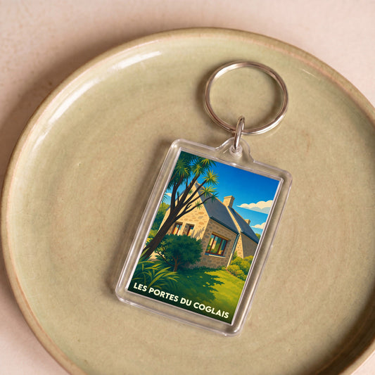 Porte-clés souvenir de la ville de Les Portes du Coglais avec une illustration stylisée.