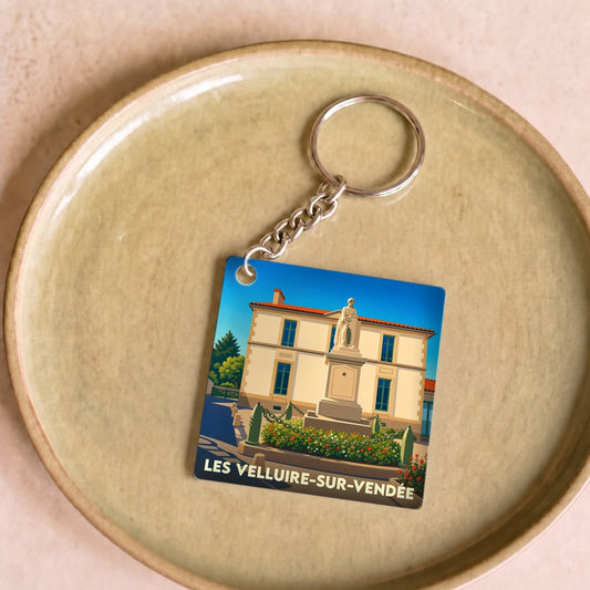 Porte-clés souvenir de la ville de Les Velluire-sur-Vendée avec une illustration stylisée.