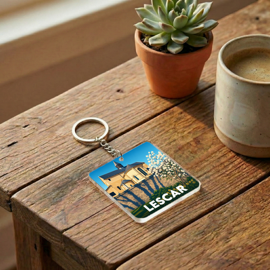 Porte-clés souvenir de la ville de Lescar avec une illustration stylisée d'un monument historique.