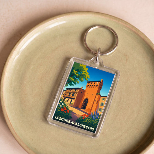 Porte-clés souvenir de la ville de Lescure-d'Albigeois avec une illustration stylisée de son patrimoine.