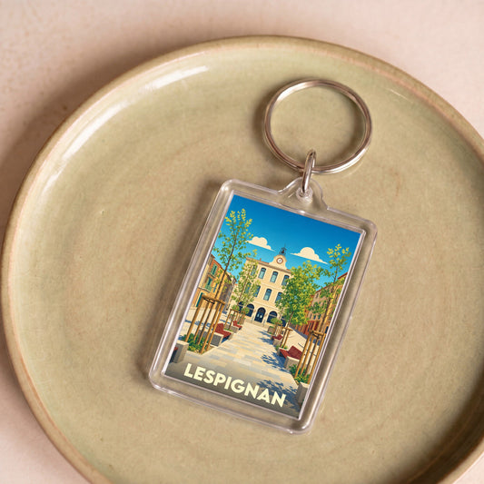Porte-clés souvenir de la ville de Lespignan avec une illustration stylisée.