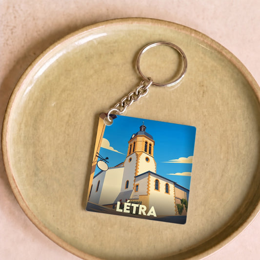 Porte-clés souvenir de la ville de Létra avec une illustration stylisée de son église.