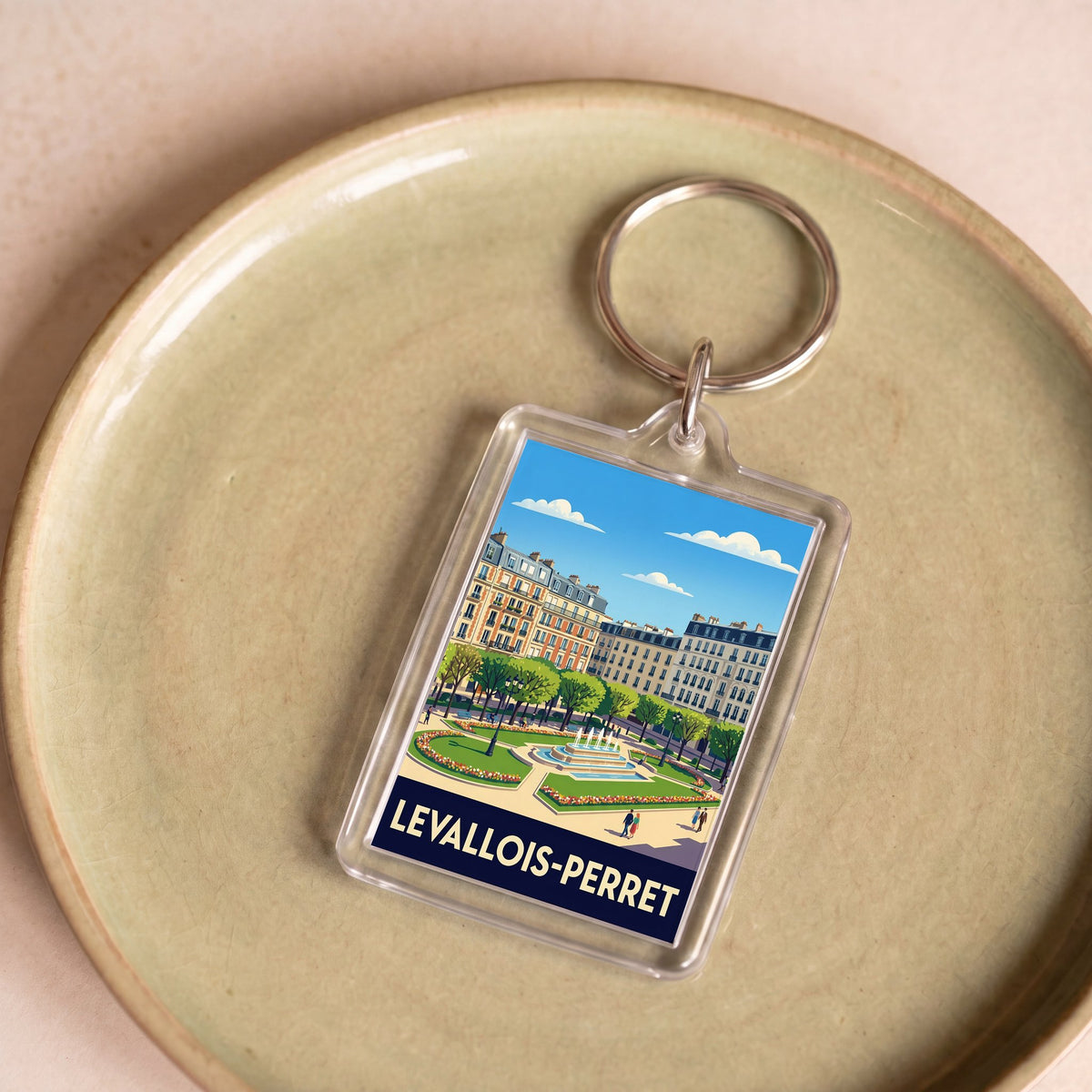 Porte-clés souvenir de la ville de Levallois-Perret avec une illustration stylisée.