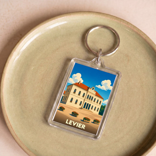 Porte-clés souvenir de la ville de Levier avec une illustration stylisée de son hôtel de ville.