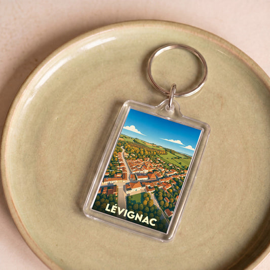 Porte-clés souvenir de la ville de Lévignac avec une illustration aérienne stylisée.
