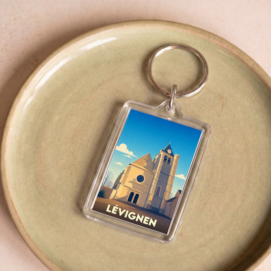 Porte-clés souvenir de la ville de Lévignen avec une illustration stylisée de son église.