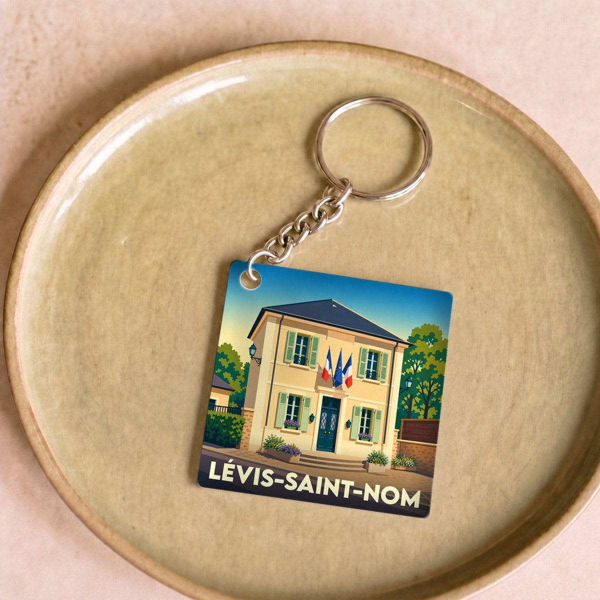 Porte-clés souvenir de la ville de Lévis-Saint-Nom avec une illustration stylisée de sa mairie.
