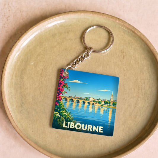 Porte-clés souvenir de la ville de Libourne avec une illustration stylisée de son pont et de ses quais.