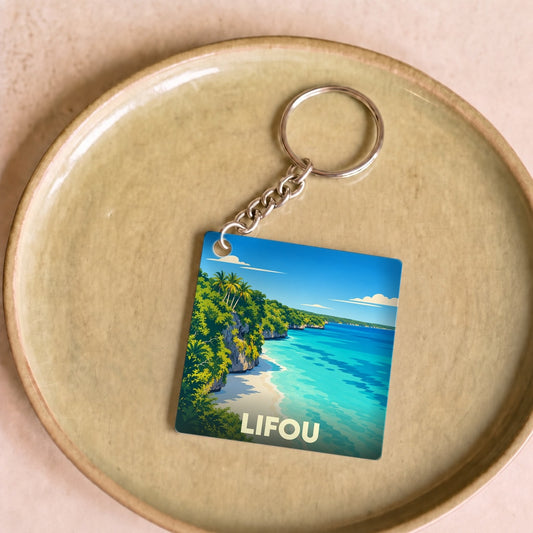 Porte-clés souvenir de la ville de Lifou avec une illustration stylisée d'un paysage côtier tropical.