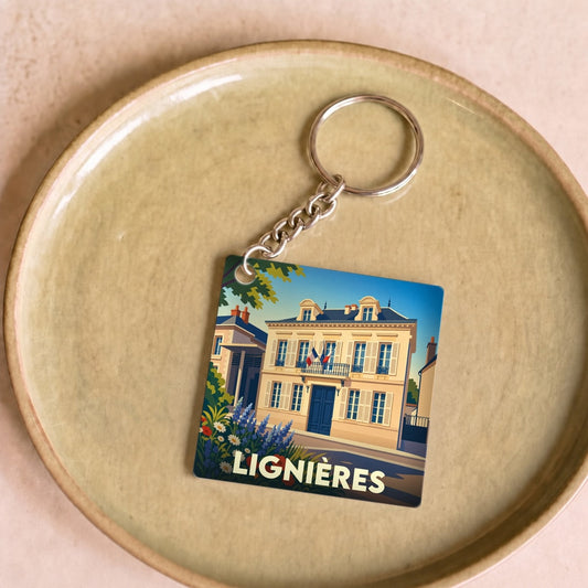 Porte-clés souvenir de la ville de Lignières avec une illustration stylisée de son hôtel de ville.