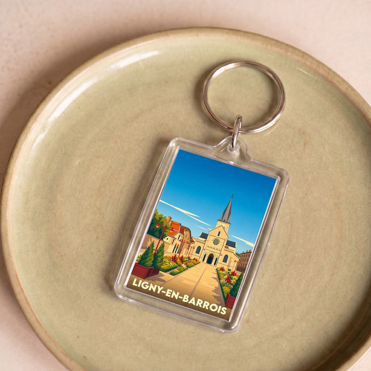 Porte-clés souvenir de la ville de Ligny-en-Barrois avec une illustration stylisée.