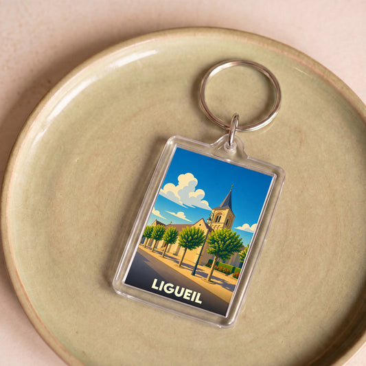Porte-clés souvenir de la ville de Ligueil avec une illustration stylisée.