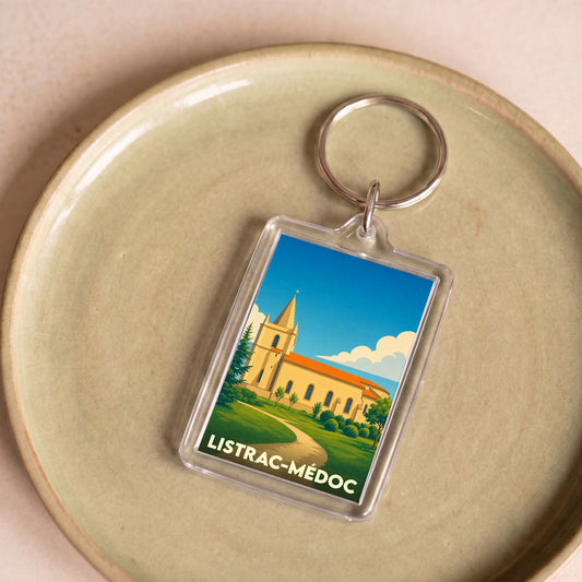 Porte-clés souvenir de la ville de Listrac-Médoc avec une illustration stylisée.