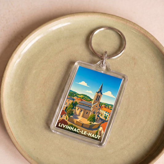 Porte-clés souvenir de la ville de Livinhac-le-Haut avec une illustration stylisée.