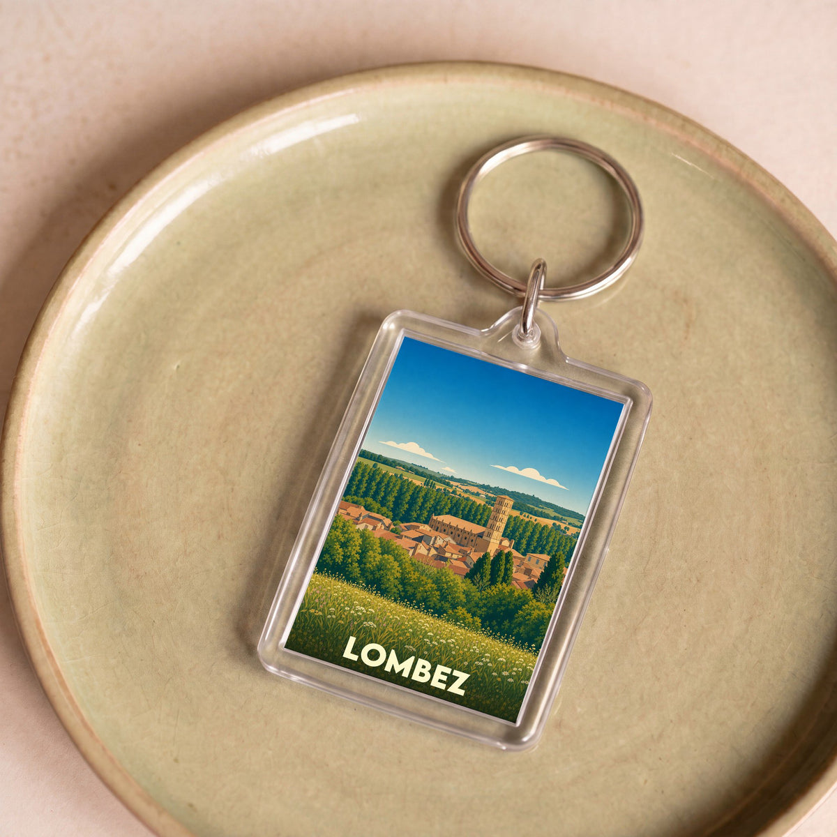 Porte-clés souvenir de la ville de Lombez avec une illustration stylisée.