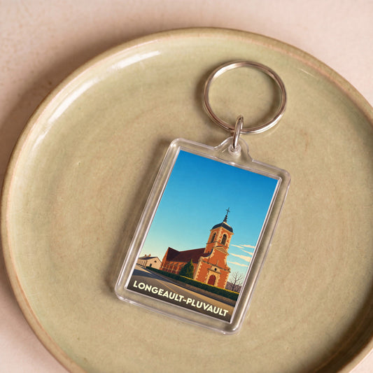 Porte-clés souvenir de la ville de Longeault-Pluvault avec une illustration stylisée de son église.