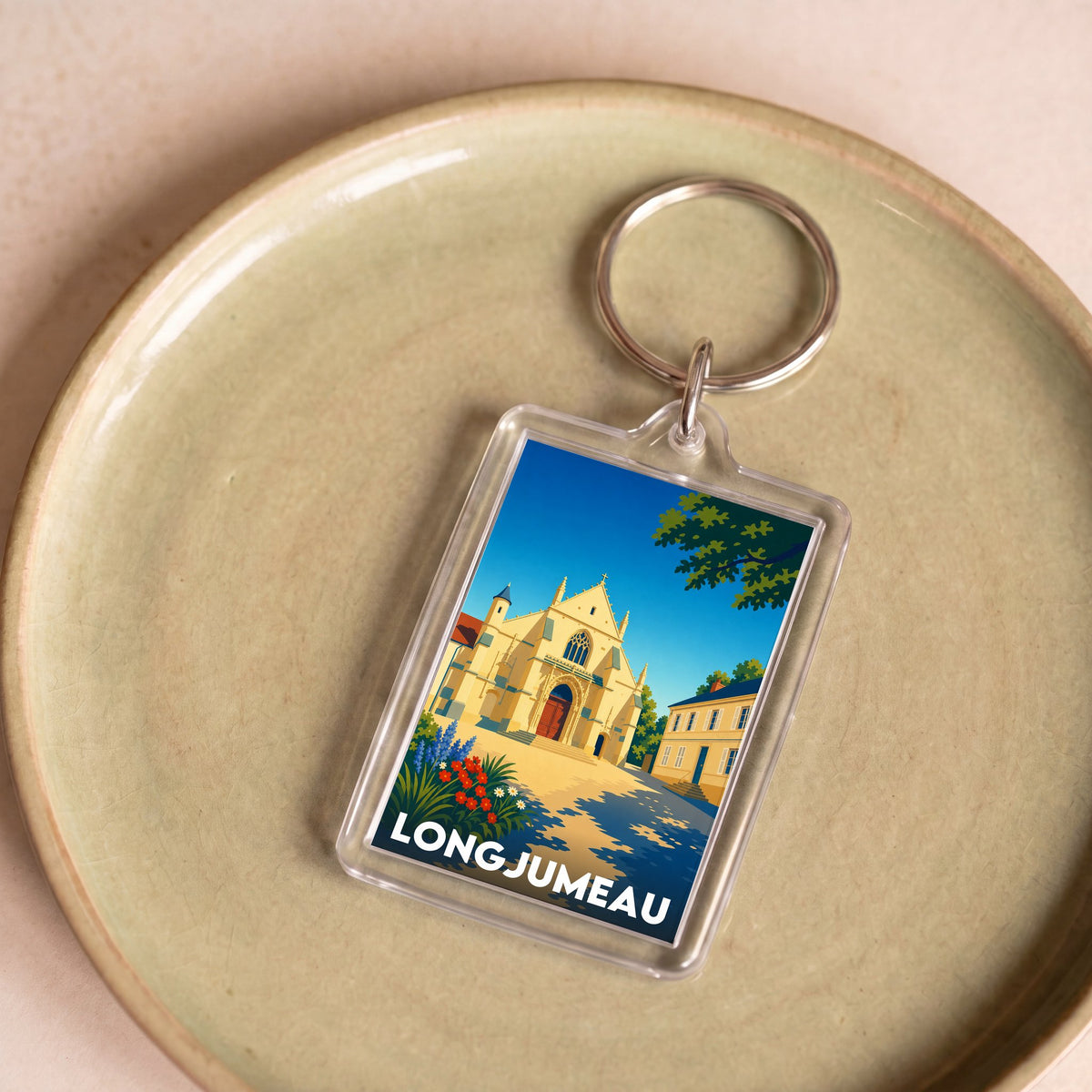Porte-clés souvenir de la ville de Longjumeau avec une illustration stylisée.