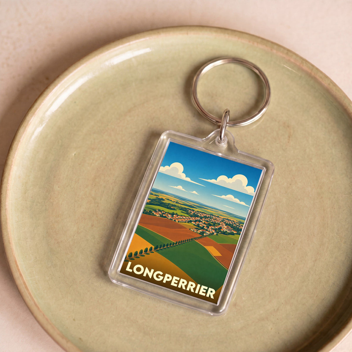 Porte-clés souvenir de la ville de Longperrier avec une illustration paysagère stylisée.