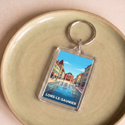 Porte-clés souvenir de la ville de Lons-le-Saunier avec une illustration stylisée.
