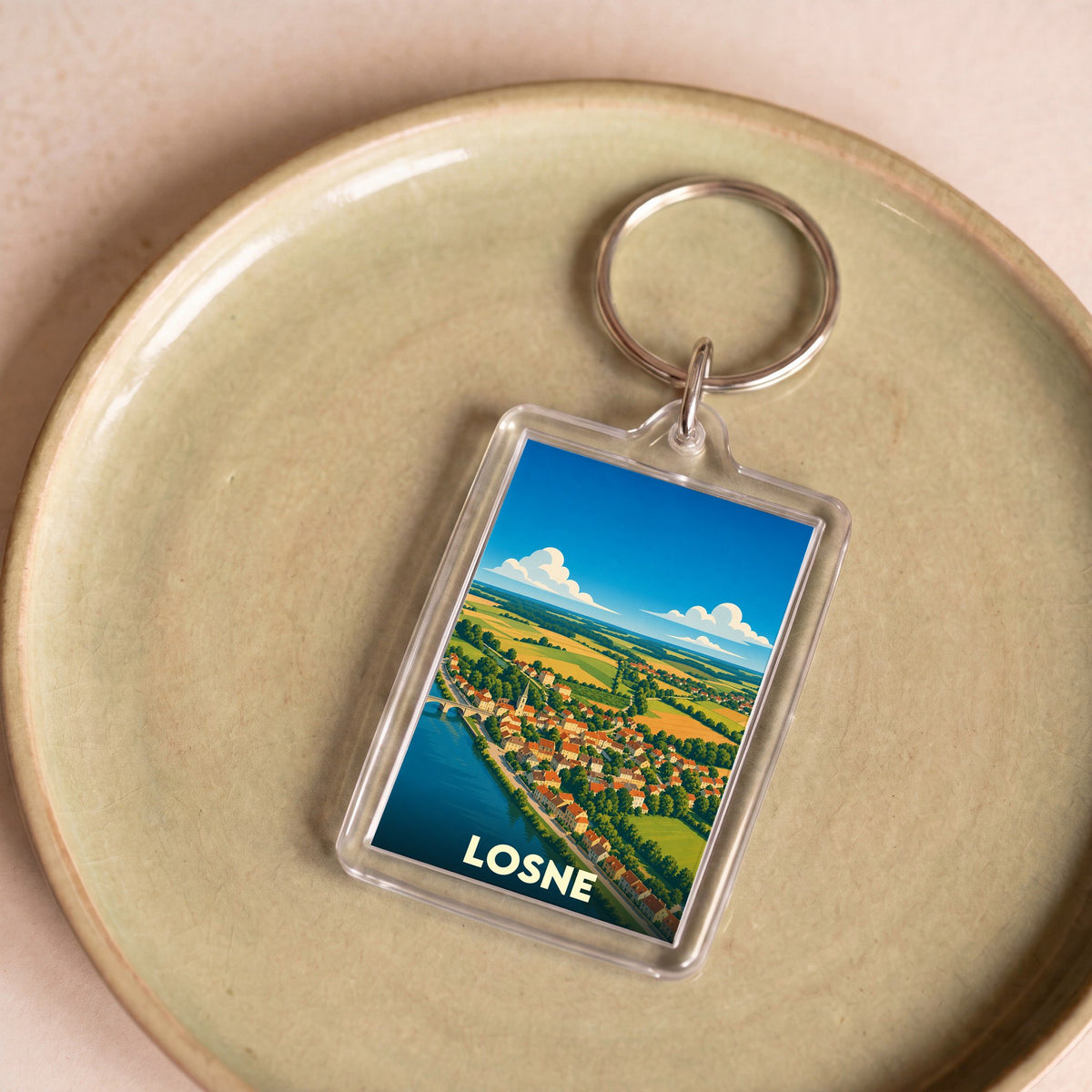 Porte-clés souvenir de la ville de Losne avec une illustration panoramique stylisée.
