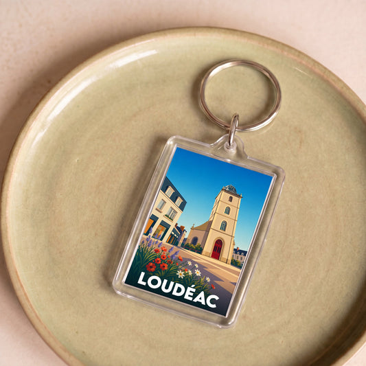 Porte-clés souvenir de la ville de Loudéac avec une illustration stylisée.