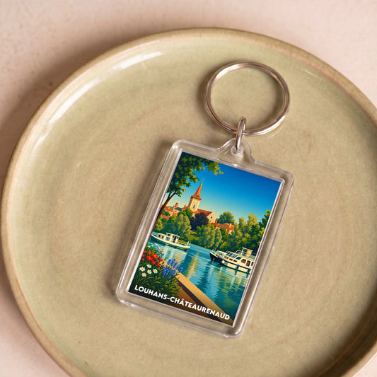 Porte-clés souvenir de la ville de Louhans-Châteaurenaud avec une illustration stylisée.