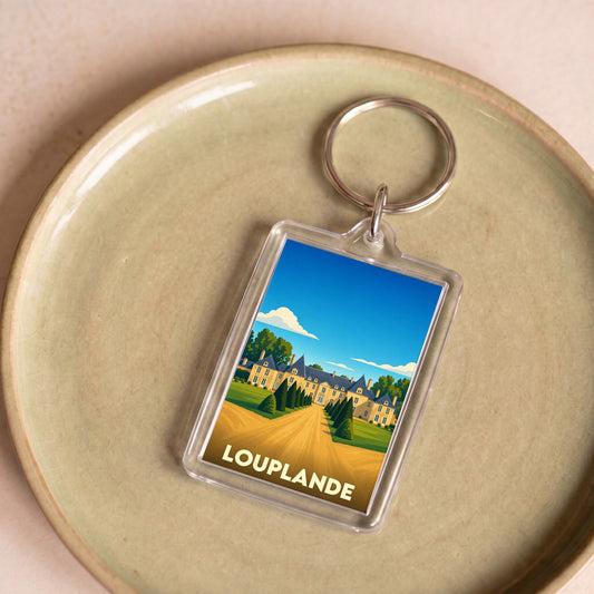 Porte-clés souvenir de la ville de Louplande avec une illustration stylisée d'un château.